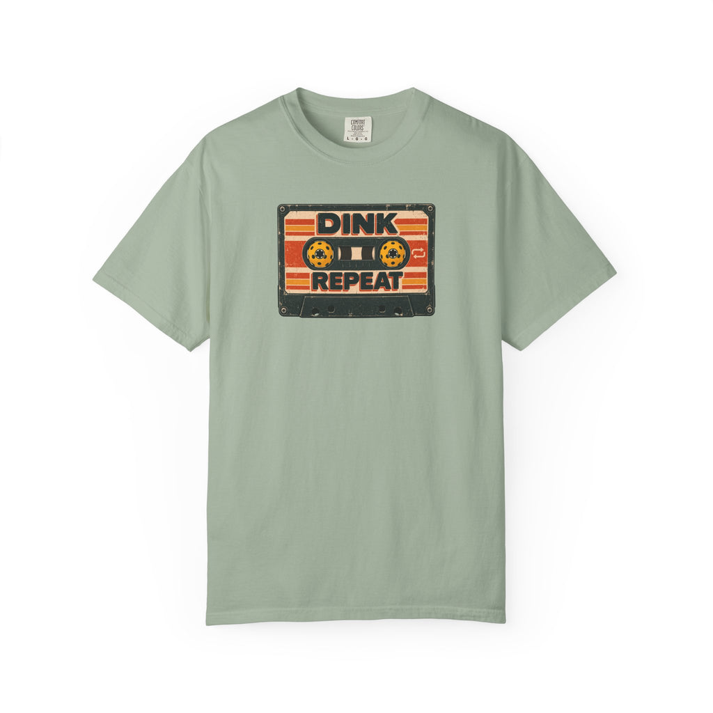 Sage colored Dink. Repeat. pickleball t-shirt with orange-and-black retro badge-style typography.