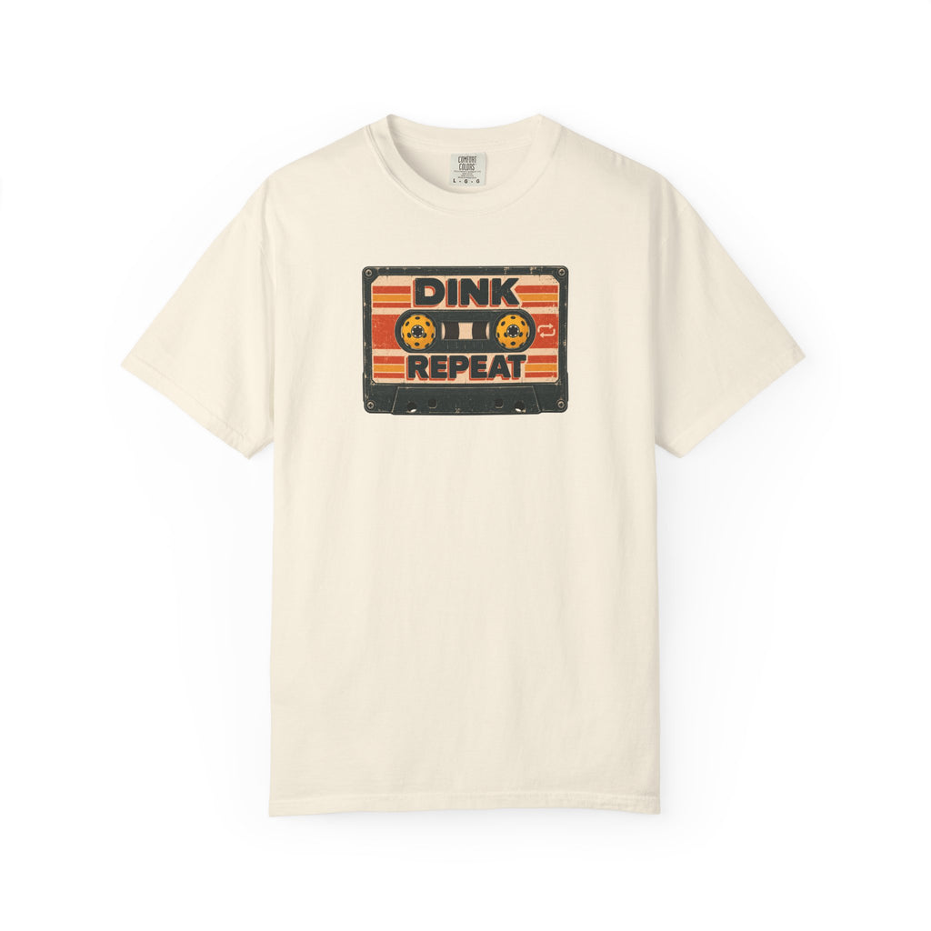 Ivory colored Dink. Repeat. pickleball t-shirt with orange-and-black retro badge-style typography.