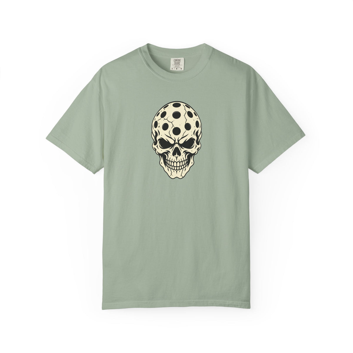 Sage colored Pickleball Skull t-shirt with skull illustration featuring perforated pickleball details.