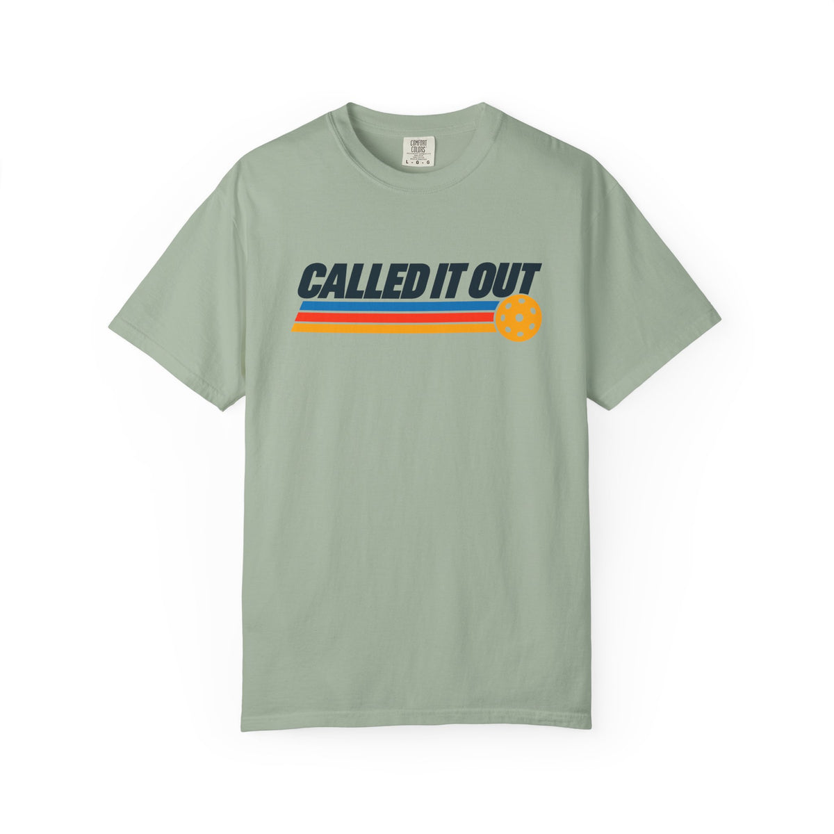 Sage colored Called It Out pickleball t-shirt with bold retro lettering and yellow pickleball accent.