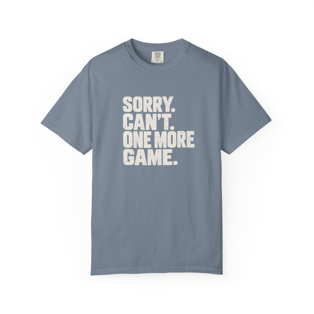 Blue-gray colored Sorry. Can't. One More Game. pickleball t-shirt with bold stacked cream typography.