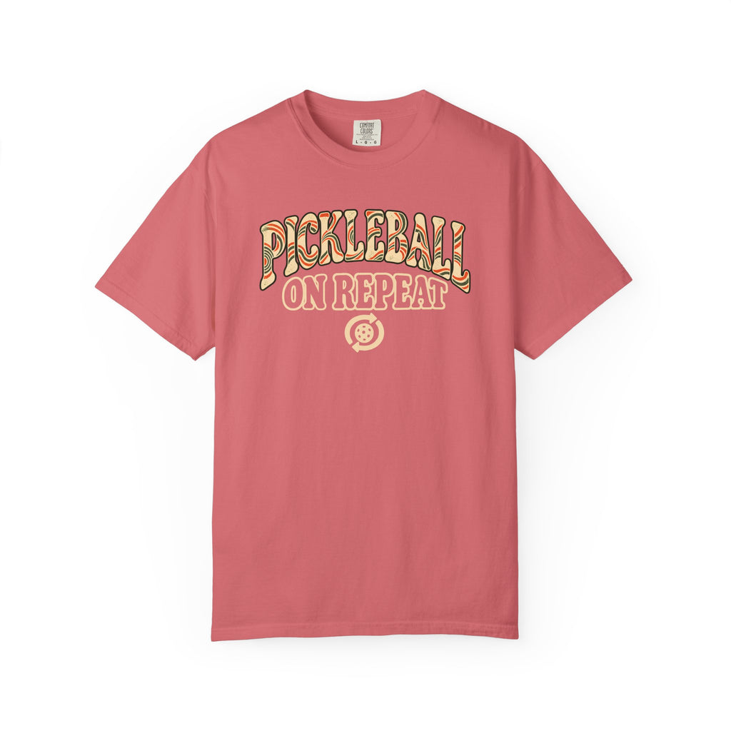 Watermelon colored Pickleball On Repeat pickleball t-shirt with warm retro varsity-style typography.