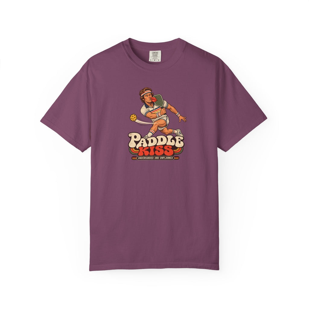 Berry colored Paddle Kiss pickleball t-shirt with playful vintage paddle-and-pickleball character graphic.