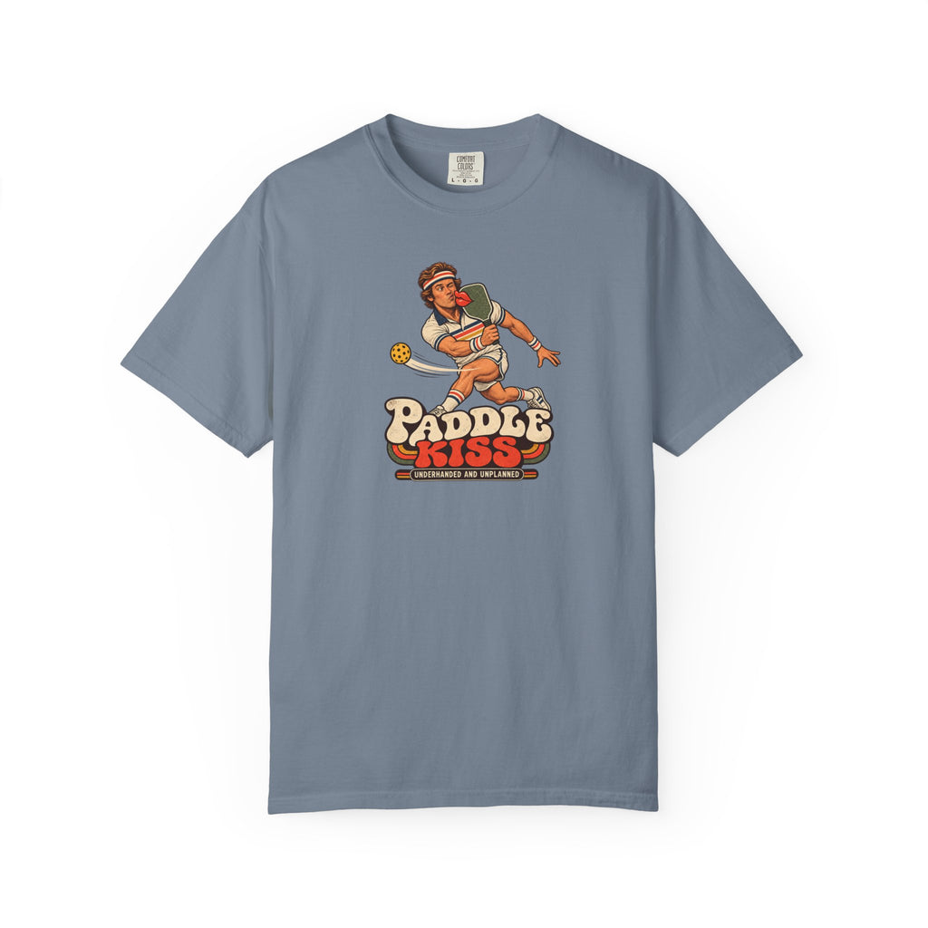Blue-gray colored Paddle Kiss pickleball t-shirt with playful vintage paddle-and-pickleball character graphic.
