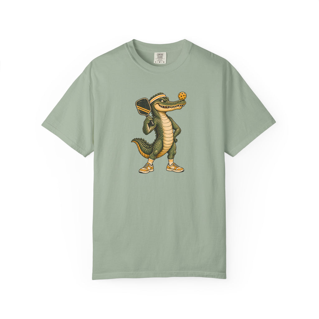 Sage colored Pickleball Gator pickleball t-shirt with cartoon alligator player holding a paddle.