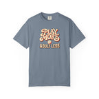 Blue-gray colored Play More Adult Less pickleball t-shirt with playful cream script typography.