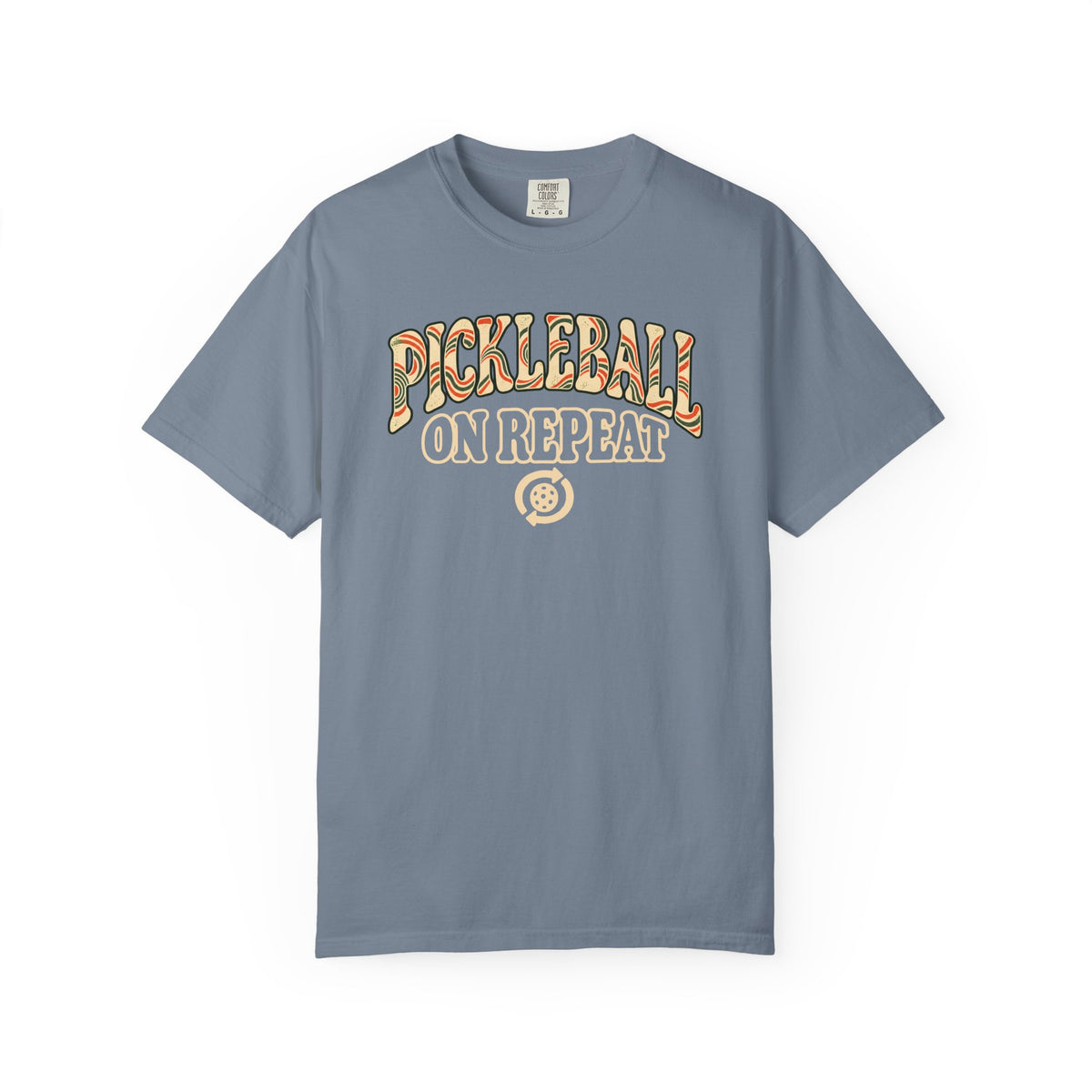 Blue-gray colored Pickleball On Repeat pickleball t-shirt with warm retro varsity-style typography.