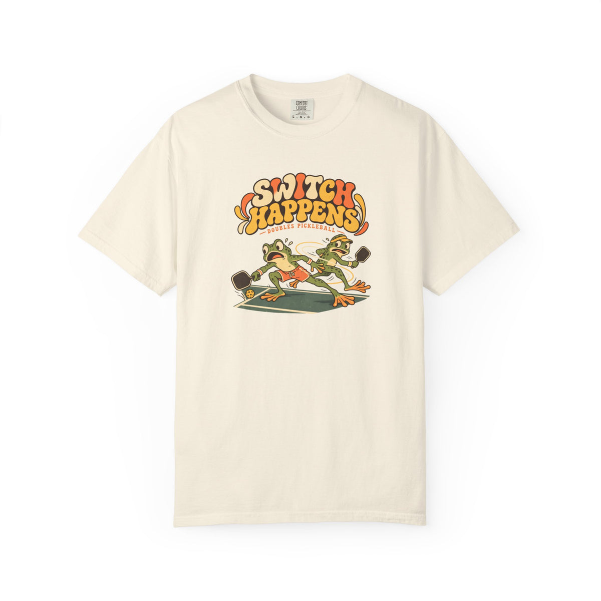 Ivory colored Switch Happens pickleball t-shirt with colorful retro court graphic and bold curved lettering.