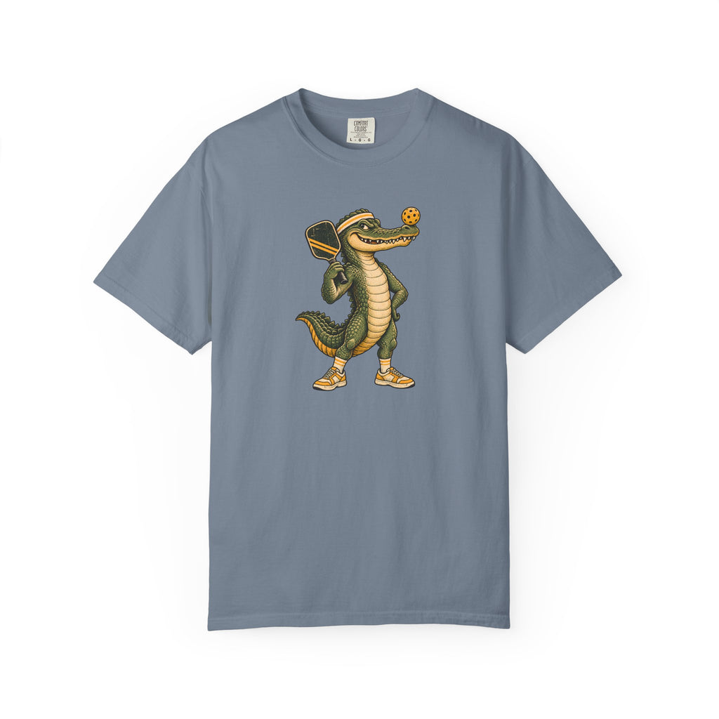 Blue-gray colored Pickleball Gator pickleball t-shirt with cartoon alligator player holding a paddle.